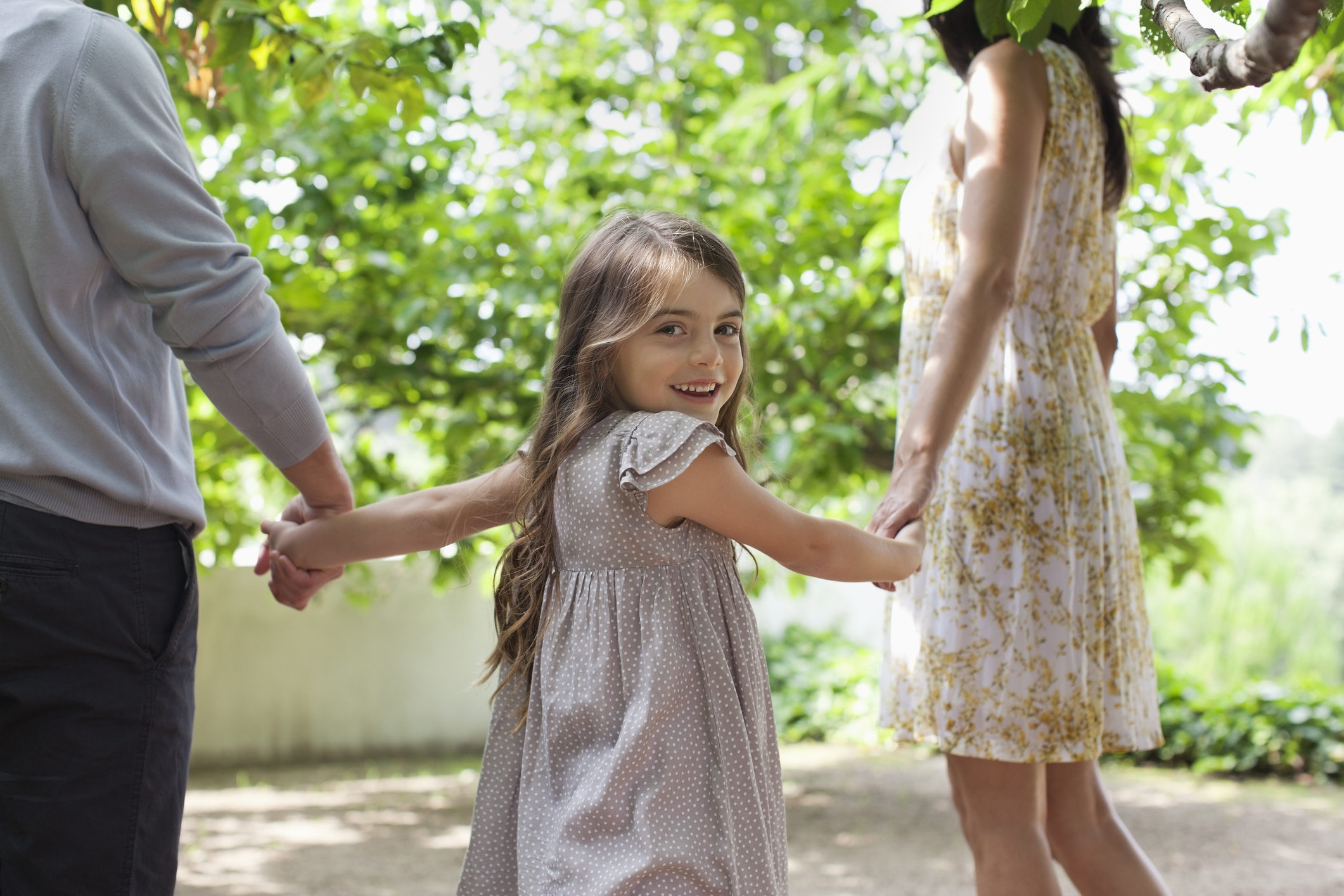 Family holding hands together outdoors Family holding hands together outdoors